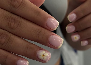 Elegant pink nails with floral design at Karas Beauty Hub, Montreal, Canada, CA.