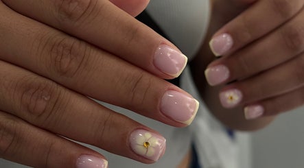 Elegant pink nails with floral design at Karas Beauty Hub, Montreal, Canada, CA.