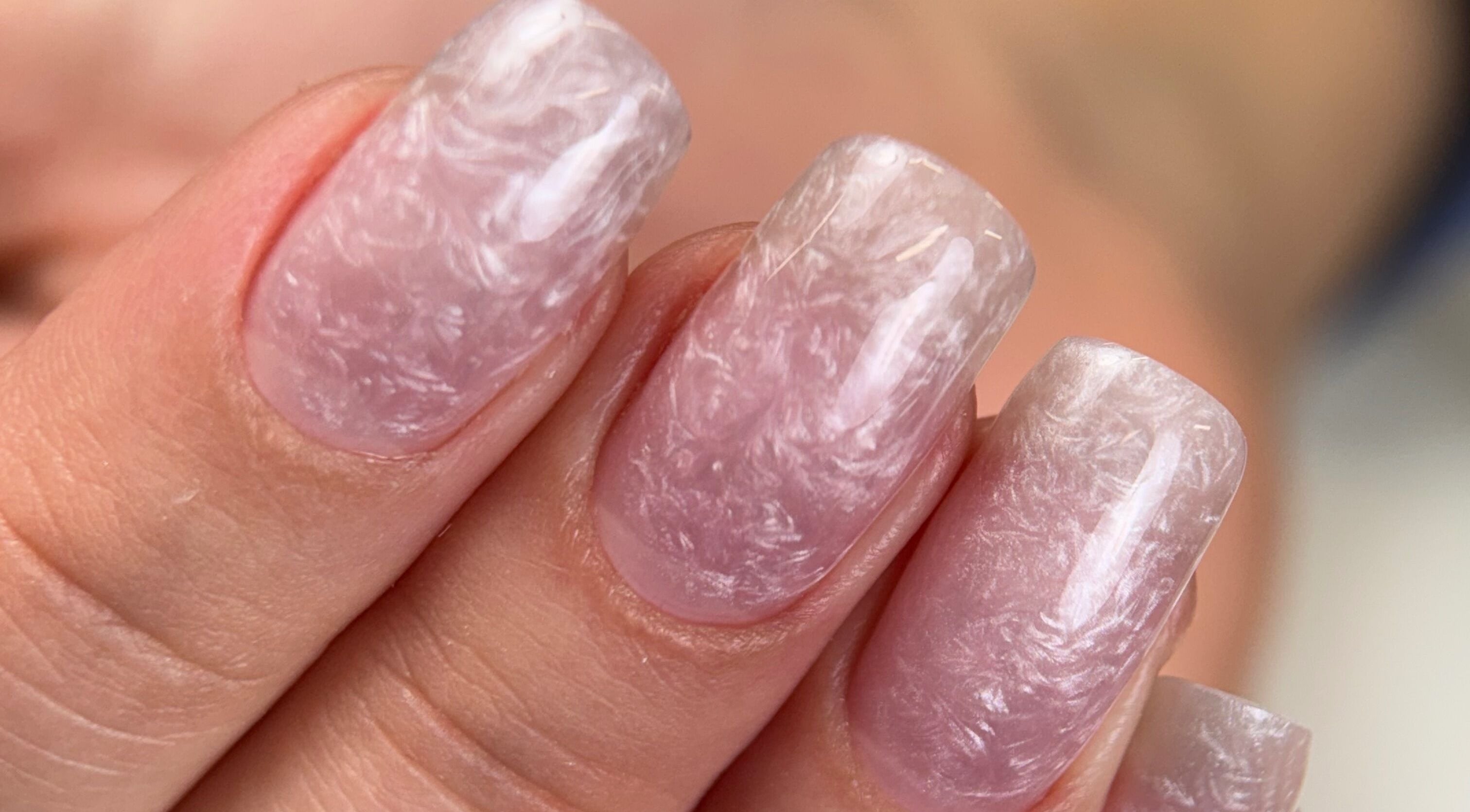 Elegant marble nail art at Karas Beauty Hub, Montreal, Canada, CA showcasing unique beauty designs.