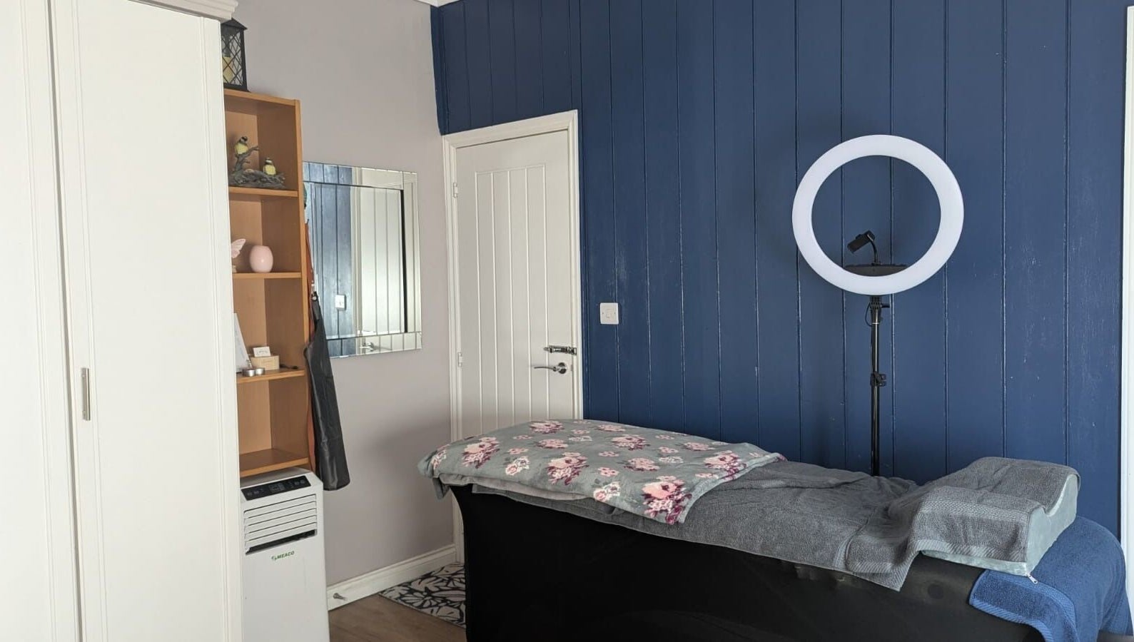 Serene beauty room at Glam Glow Grace in Mapplewell, England, GB featuring a treatment bed and ring light.