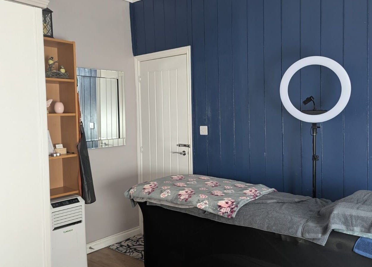 Serene beauty room at Glam Glow Grace in Mapplewell, England, GB featuring a treatment bed and ring light.