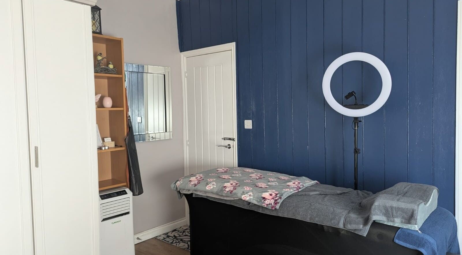 Serene beauty room at Glam Glow Grace in Mapplewell, England, GB featuring a treatment bed and ring light.