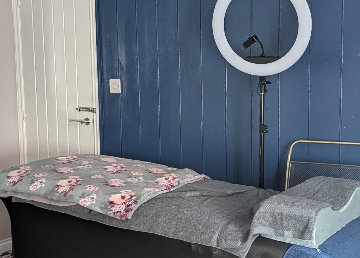 Tranquil therapy room at Glam Glow Grace, Mapplewell, England, GB with massage table and soft lighting.