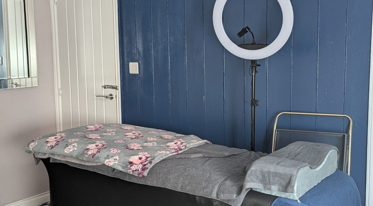 Tranquil therapy room at Glam Glow Grace, Mapplewell, England, GB with massage table and soft lighting.