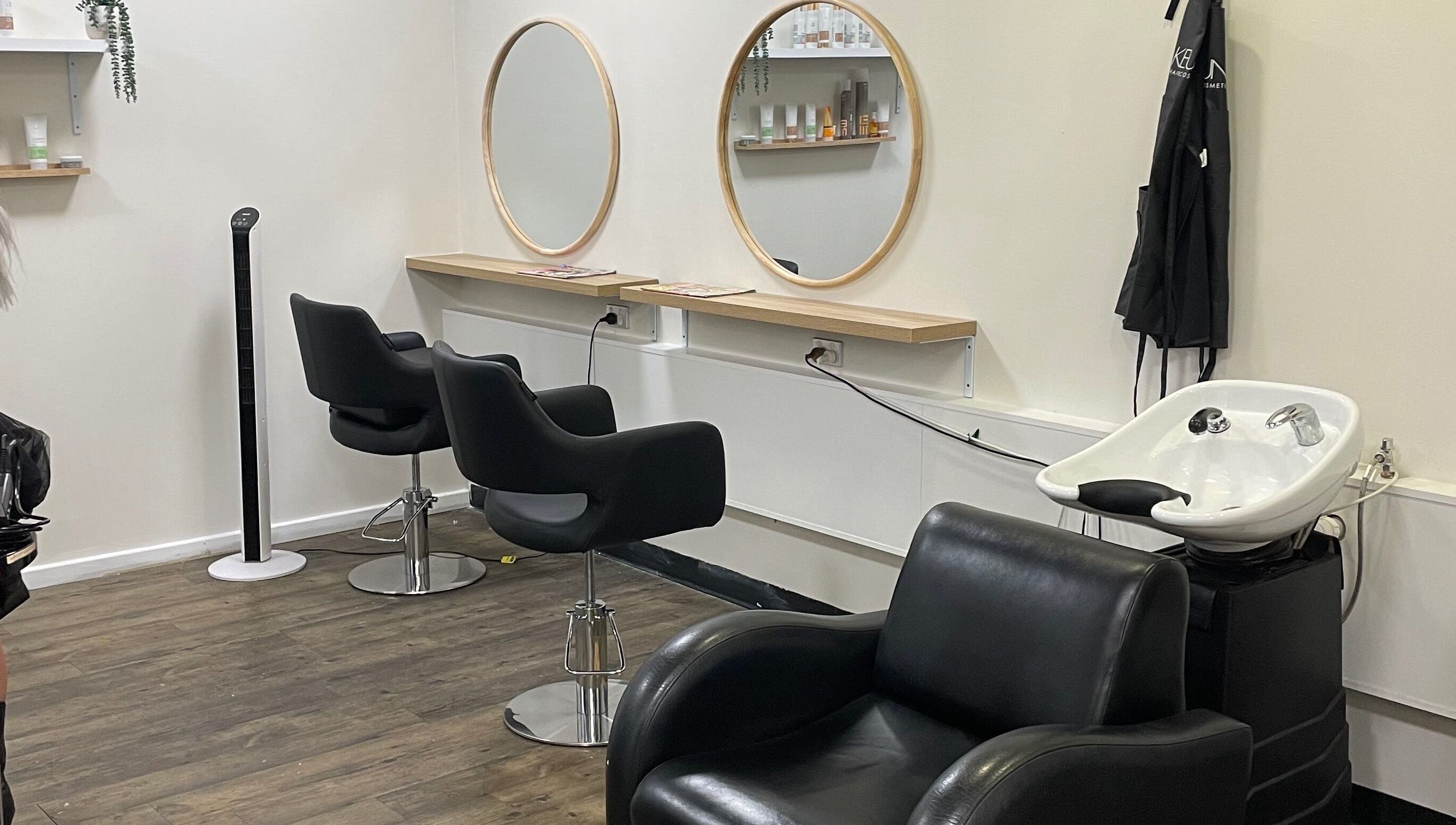 Modern salon interior at JMD Hair Art Malaga, featuring stylish chairs and mirrors in Malaga, Western Australia, AU.