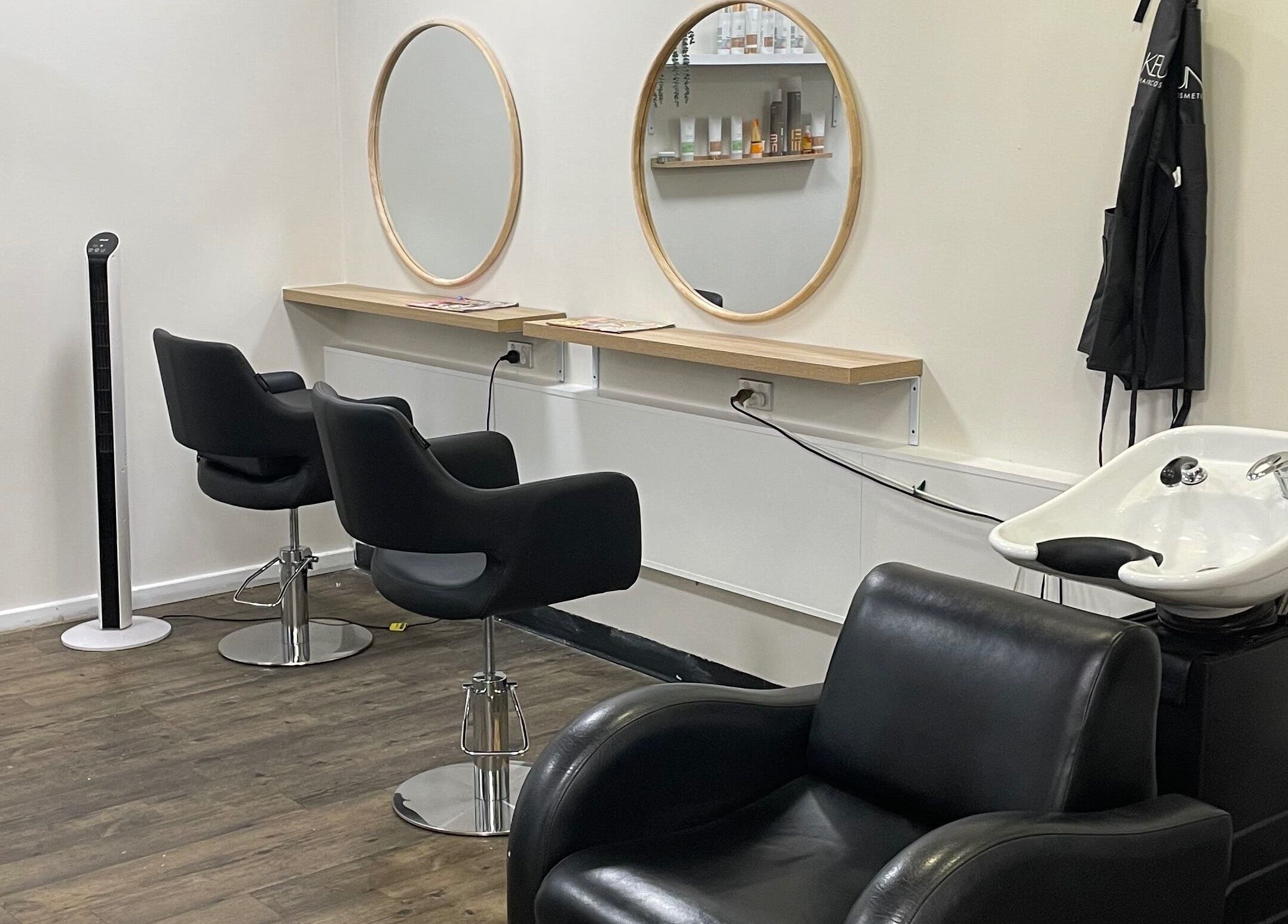 Modern salon interior at JMD Hair Art Malaga, featuring stylish chairs and mirrors in Malaga, Western Australia, AU.