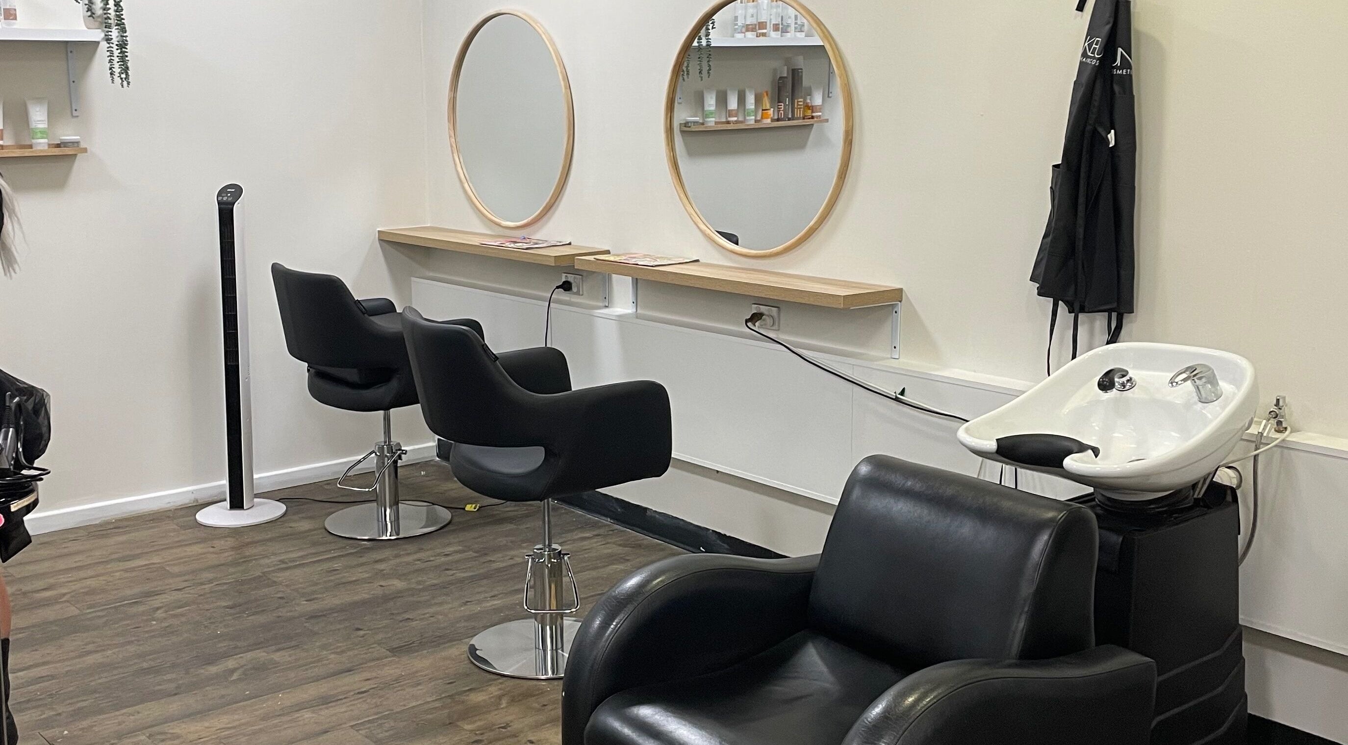 Modern salon interior at JMD Hair Art Malaga, featuring stylish chairs and mirrors in Malaga, Western Australia, AU.