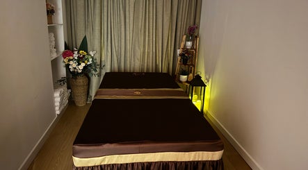 Tranquil massage room at Ve La Dee Thai Spa, Manchester, England, GB, featuring a plush table and elegant decor.