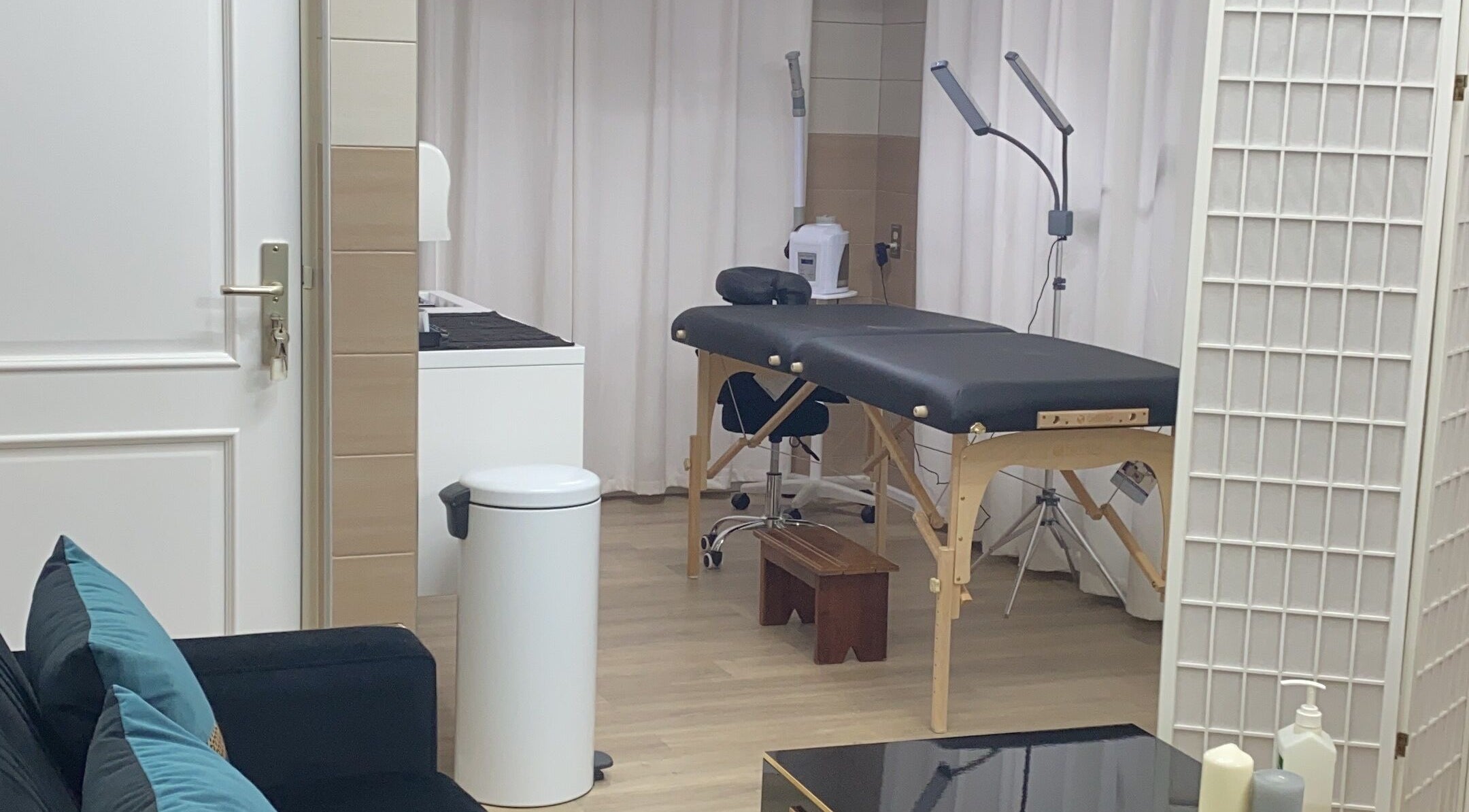 Elegant treatment room at The Salon, Paramaribo, Paramaribo, SR with massage table and ambient lighting.