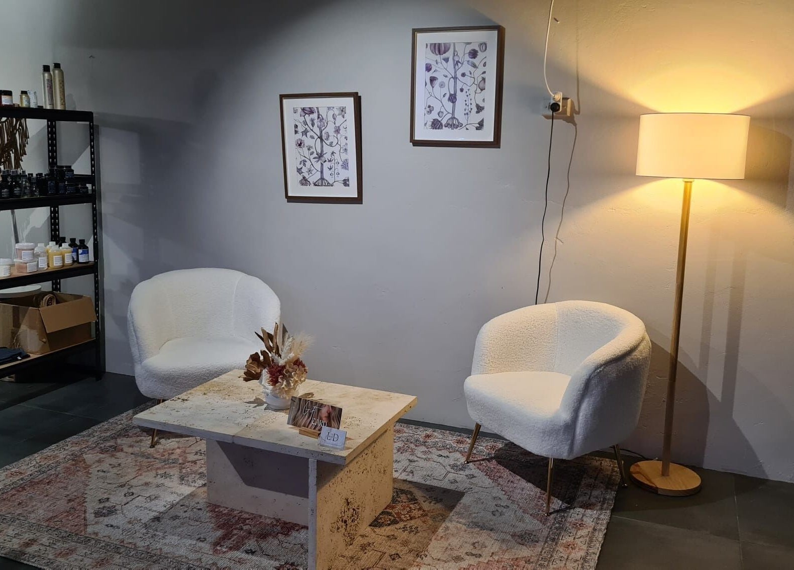 Elegant lounge area at Home Salon by Laurine Durand, Stafford, Queensland, AU with chairs, lamp, decor.