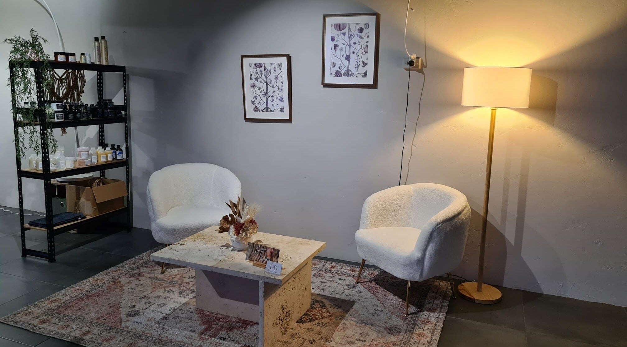 Elegant lounge area at Home Salon by Laurine Durand, Stafford, Queensland, AU with chairs, lamp, decor.