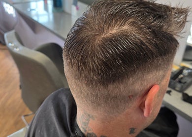 Modern haircut at Kourtneys Lovely Locks, Newbury, England, GB. Perfectly groomed for a polished look.