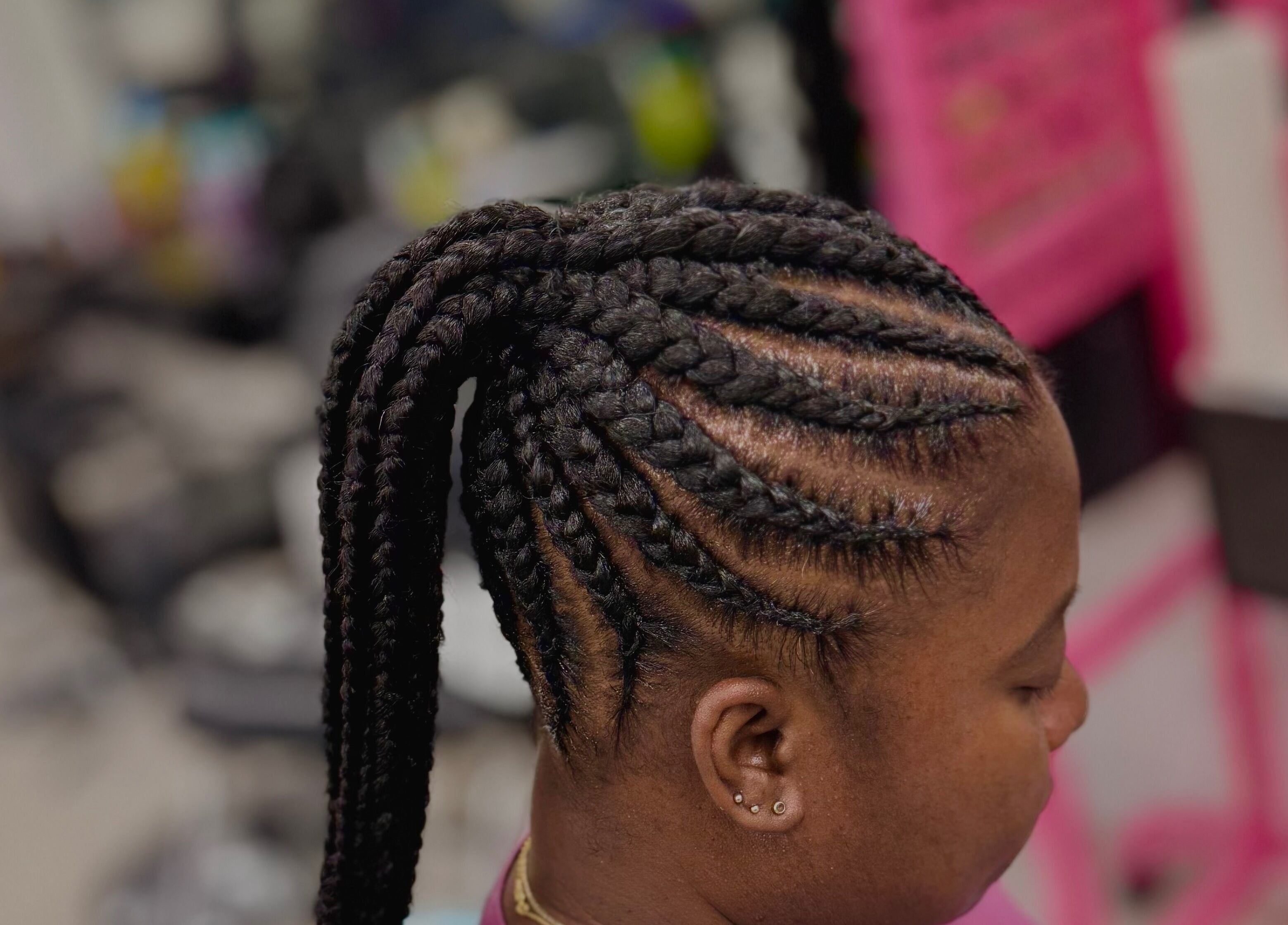 Intricate braided hairstyle at Funmi’s, New York, New York, US, showcasing expert styling.