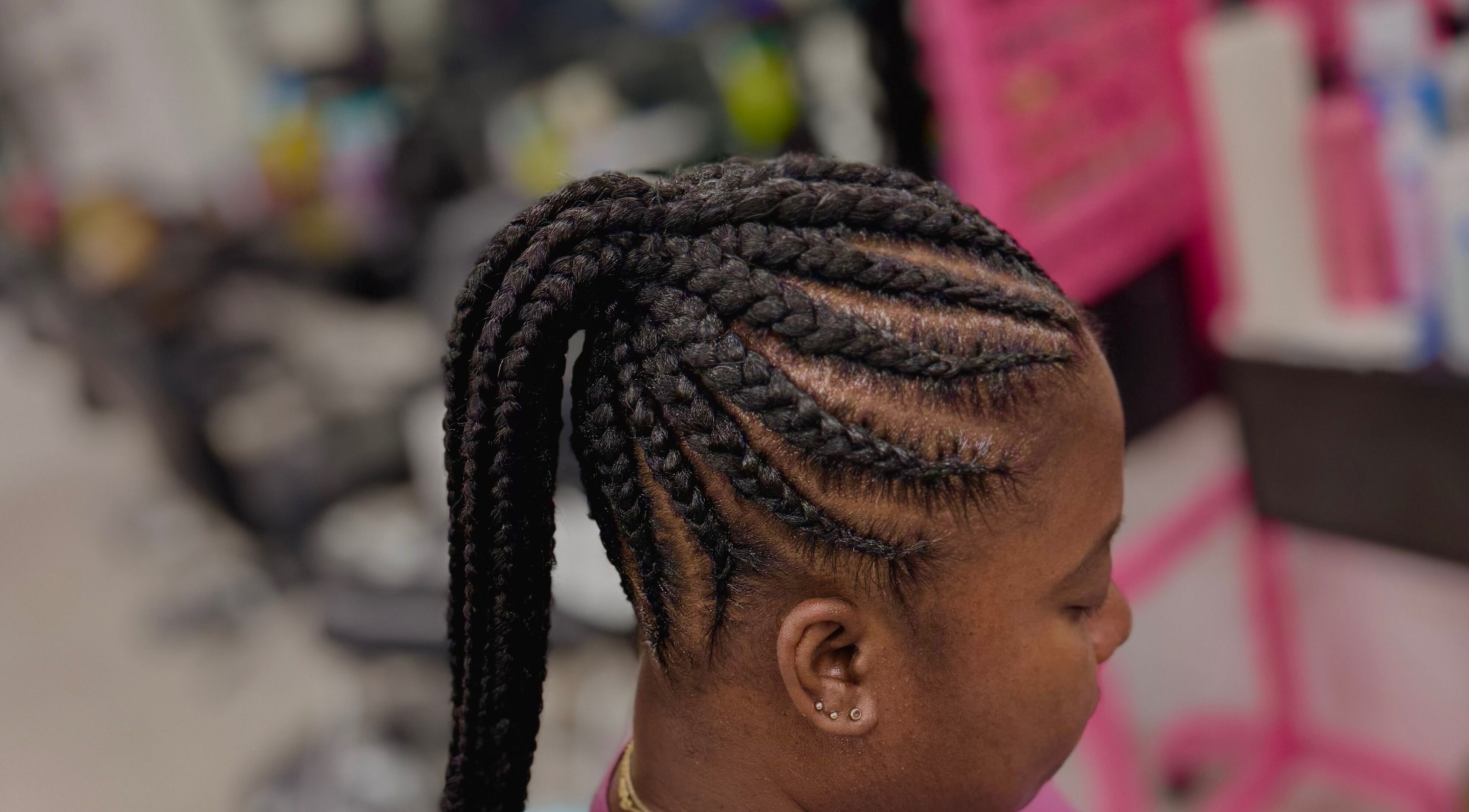 Intricate braided hairstyle at Funmi’s, New York, New York, US, showcasing expert styling.