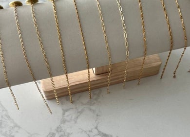 Elegant gold chains displayed on a soft stand at LINKED (Mobile Home Appointments UAE), Dubai, AE.