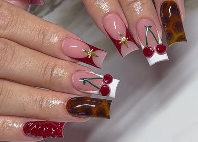 Elegant cherry-themed nail art by Amhnailz, Las Vegas, Nevada, US. Unique designs showcase creative style.