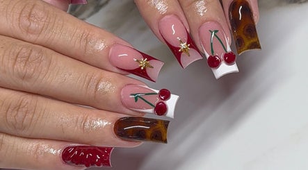 Elegant cherry-themed nail art by Amhnailz, Las Vegas, Nevada, US. Unique designs showcase creative style.
