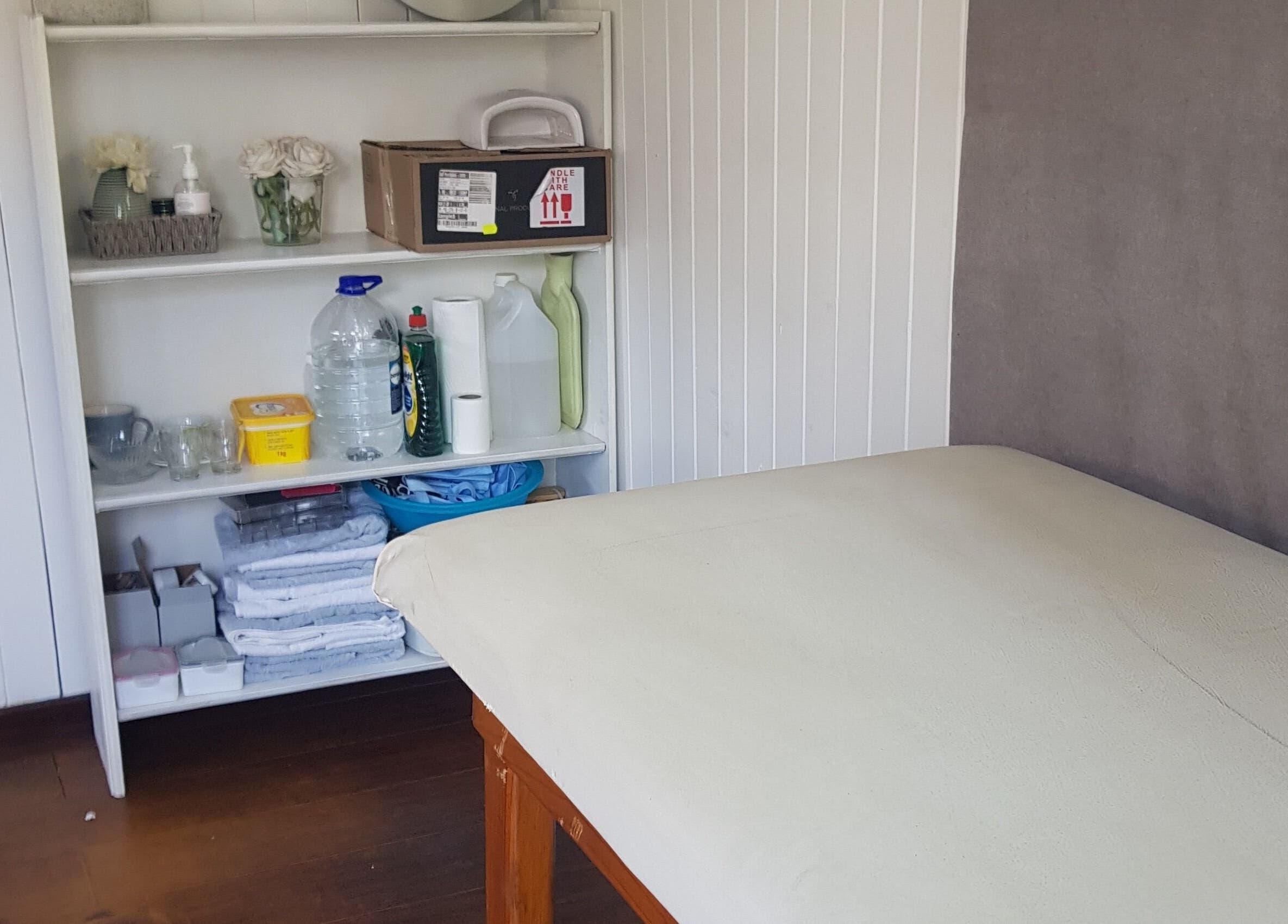 Cozy treatment room at Khanyi's graCefulTouch nails and beauty studio, Sandton, Gauteng, ZA with a massage bed.