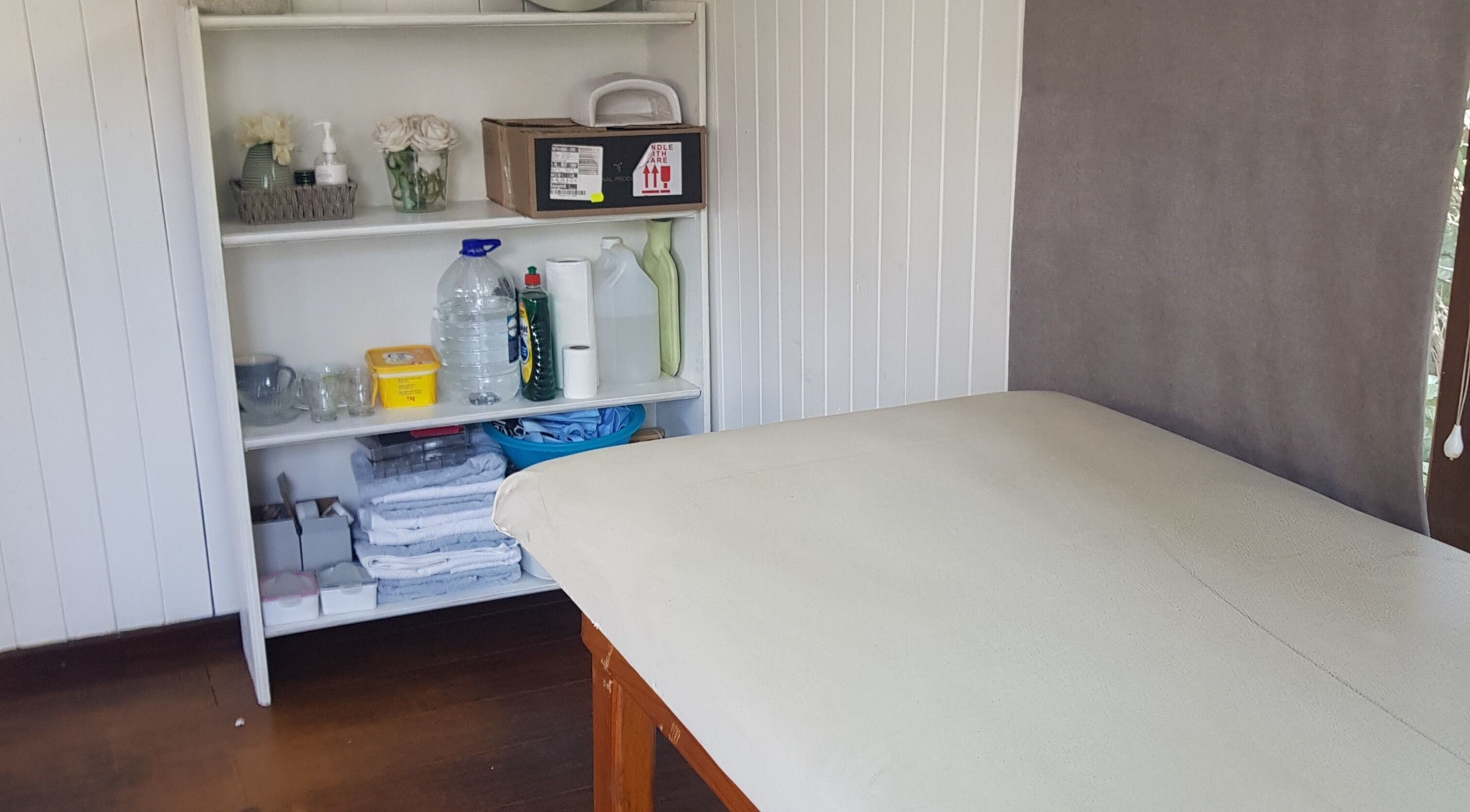 Cozy treatment room at Khanyi's graCefulTouch nails and beauty studio, Sandton, Gauteng, ZA with a massage bed.