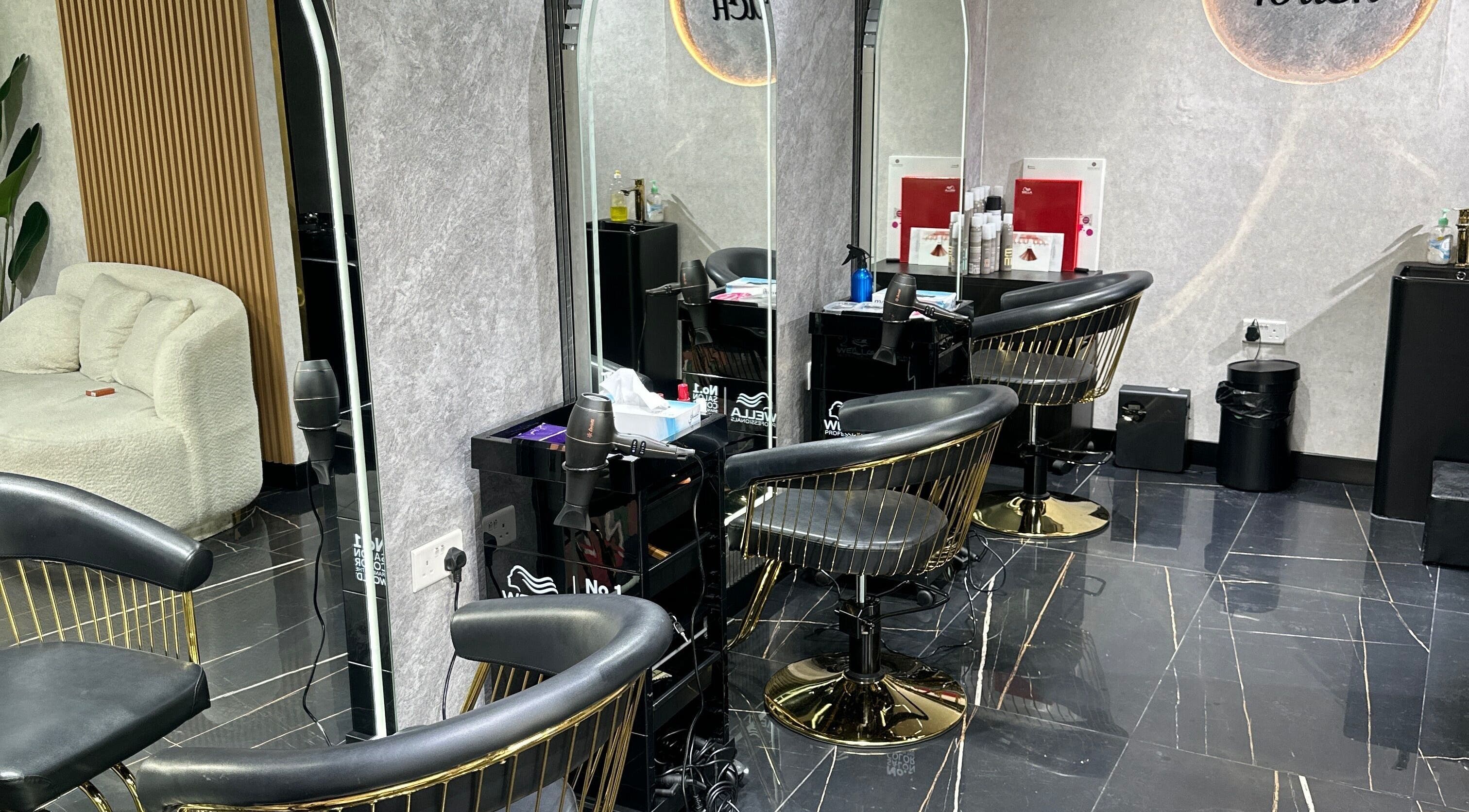 Modern salon interior at Luxury Touch Beauty Salon in Dubai, Dubai, AE, featuring stylish black chairs and decor.