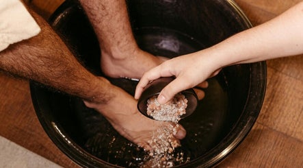 Salt being poured into a foot bath at JY Aromatherapy, Bayan Lepas, Penang, MY for a soothing detox experience.