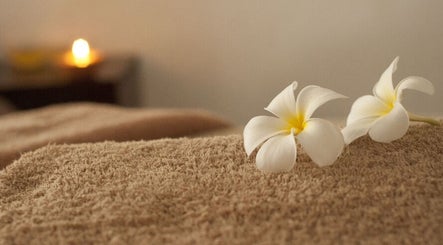 Plumeria flowers on a massage table at JY Aromatherapy, Bayan Lepas, Penang, MY, evoking relaxation and tranquility.