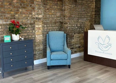 Inviting waiting area at Alina N. Sports Massage, Barnet, England, GB featuring a chair, table, and desk.
