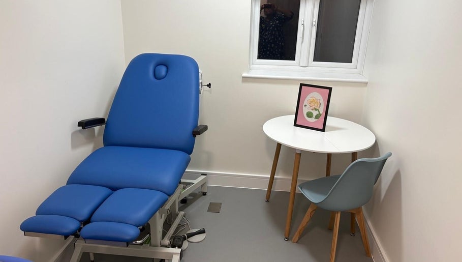 Calming treatment room at Alina N. Sports Massage in London, England, GB with a blue massage chair and decor.