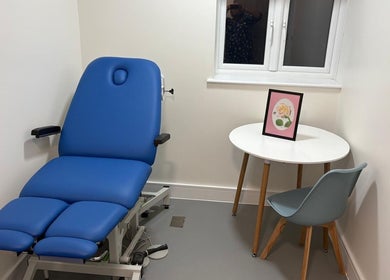 Calming treatment room at Alina N. Sports Massage in London, England, GB with a blue massage chair and decor.
