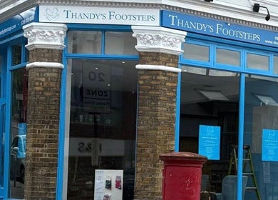 Exterior of Alina N. Sports Massage with blue windows in London, England, GB, reflecting the vibrant city vibe.