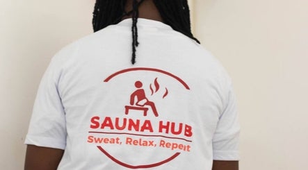Back view of person wearing Sauna Hub Ghana t-shirt in Madina, Greater Accra Region, GH.
