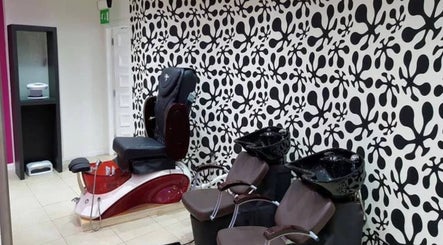Modern salon seating at Mina Kokosh, Glasgow, Scotland, GB, featuring bold black and white wall design.