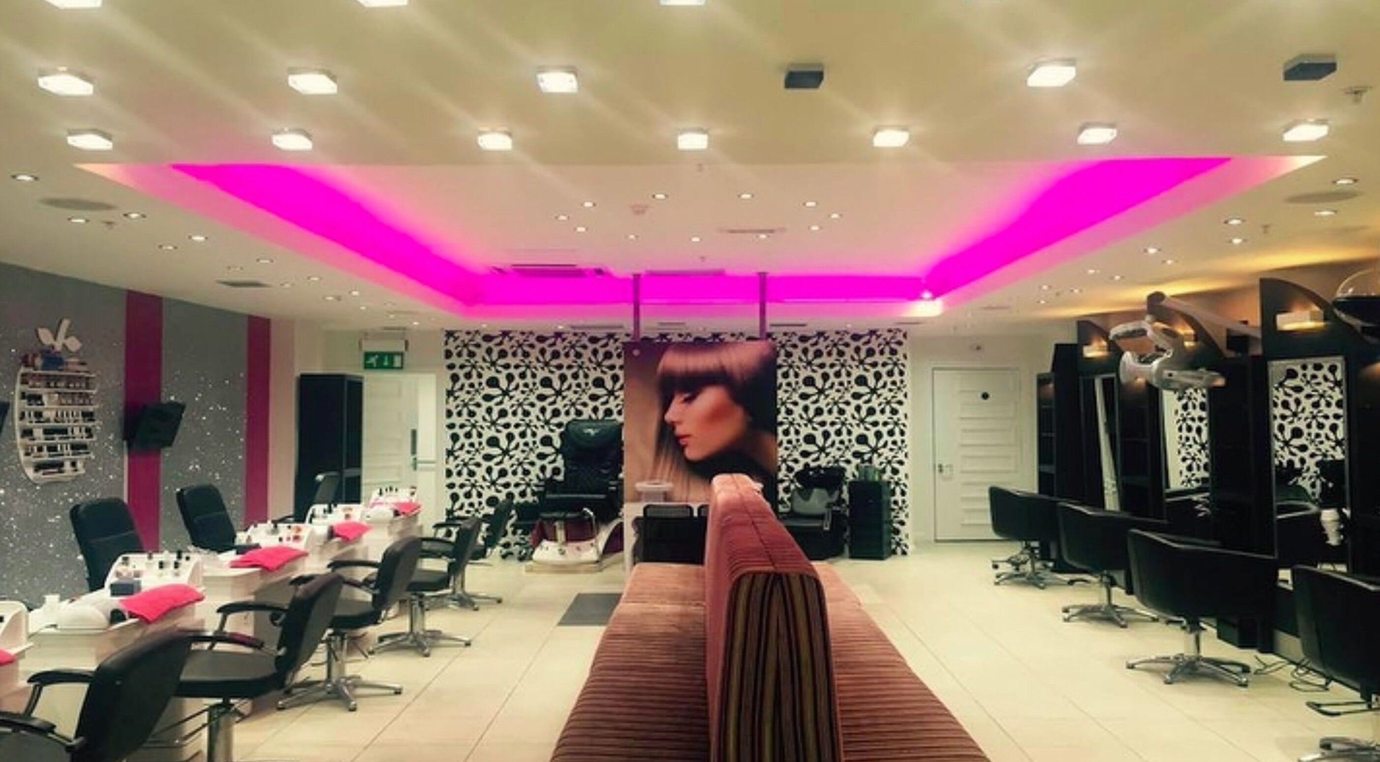 Elegant salon interior at Mina Kokosh Hair & Beauty, Glasgow, Scotland, GB with modern chairs and stylish decor.