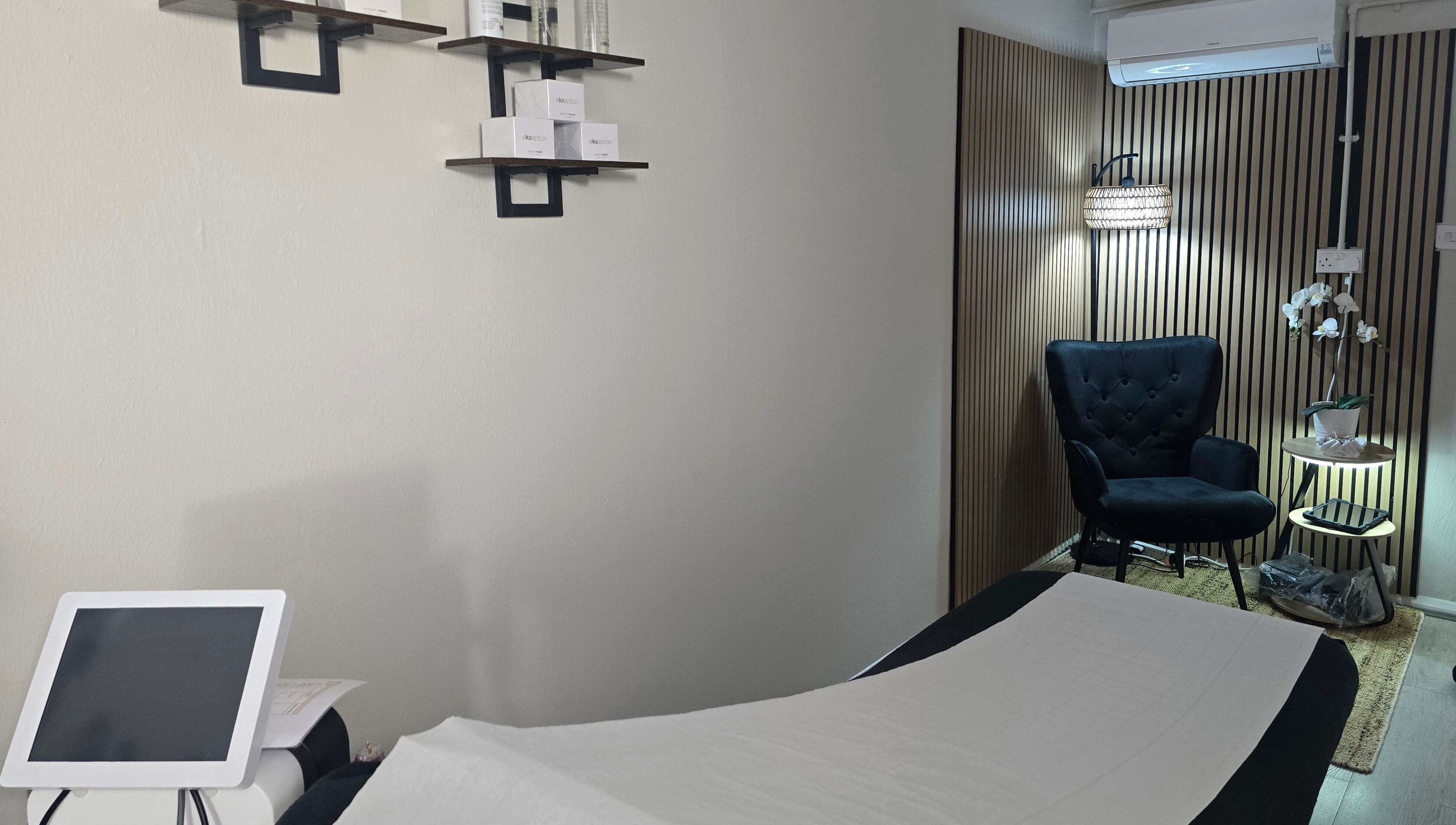 Elegant treatment room at Face it by Ian, Walton-on-Thames, England, GB with a plush chair and soothing decor.