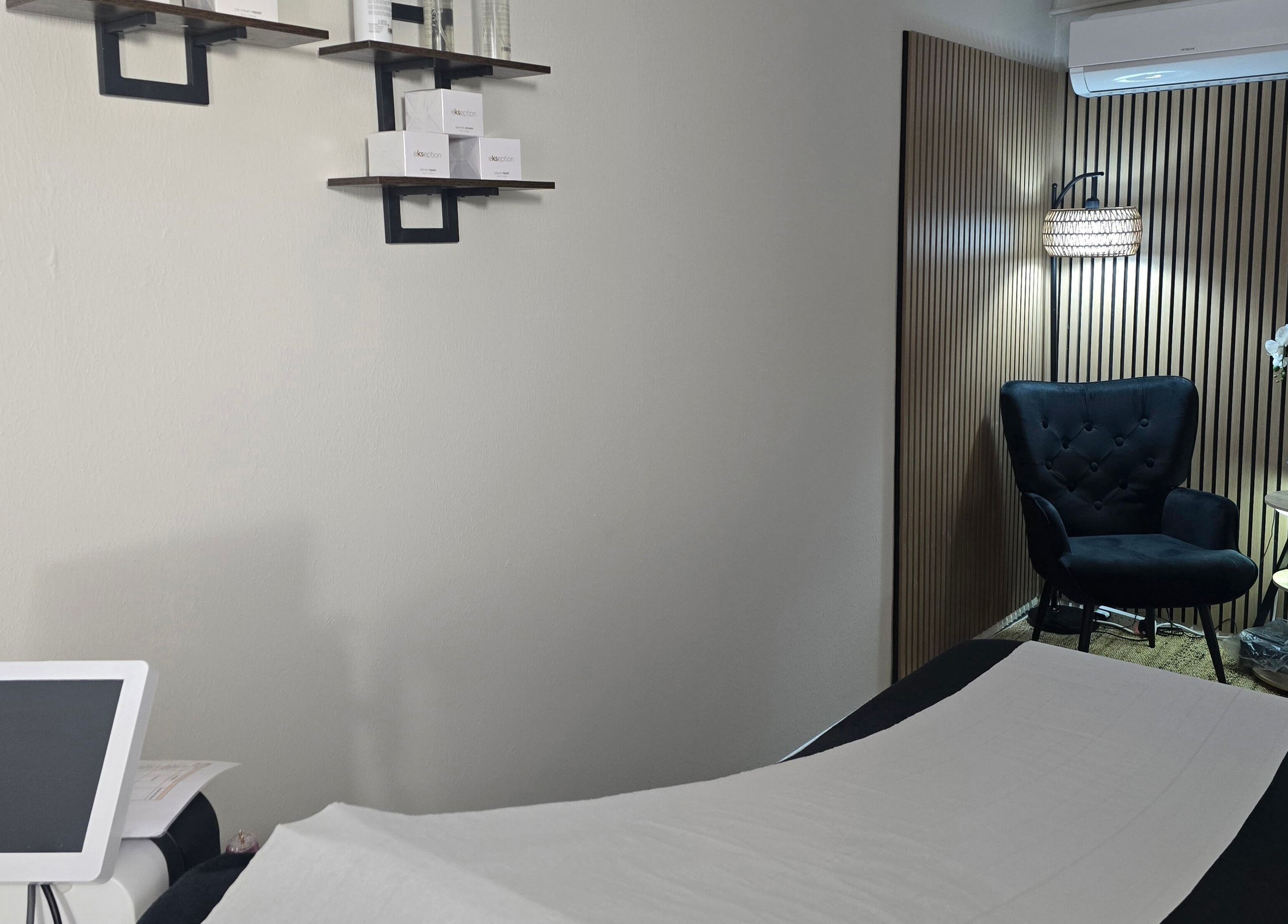 Elegant treatment room at Face it by Ian, Walton-on-Thames, England, GB with a plush chair and soothing decor.