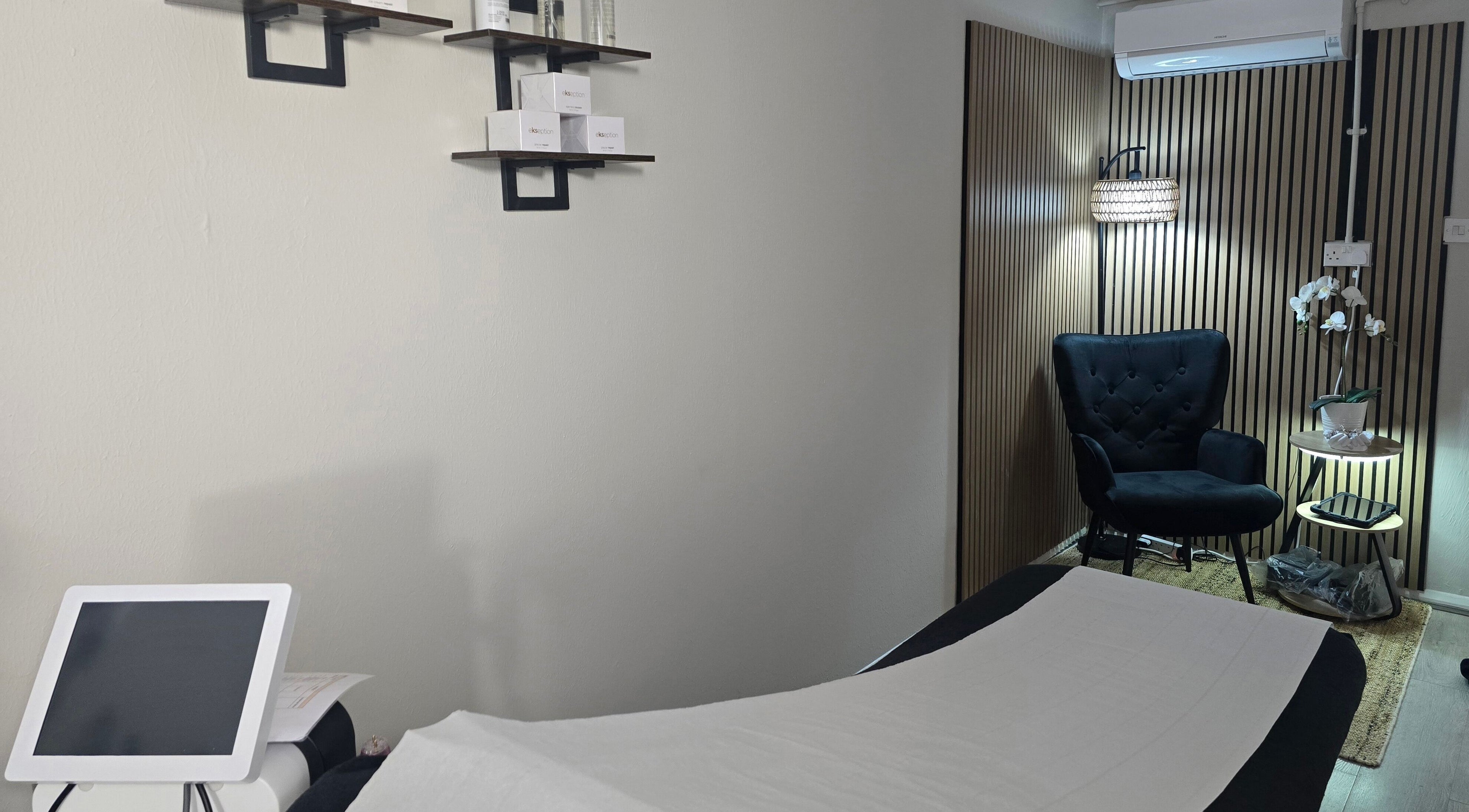 Elegant treatment room at Face it by Ian, Walton-on-Thames, England, GB with a plush chair and soothing decor.