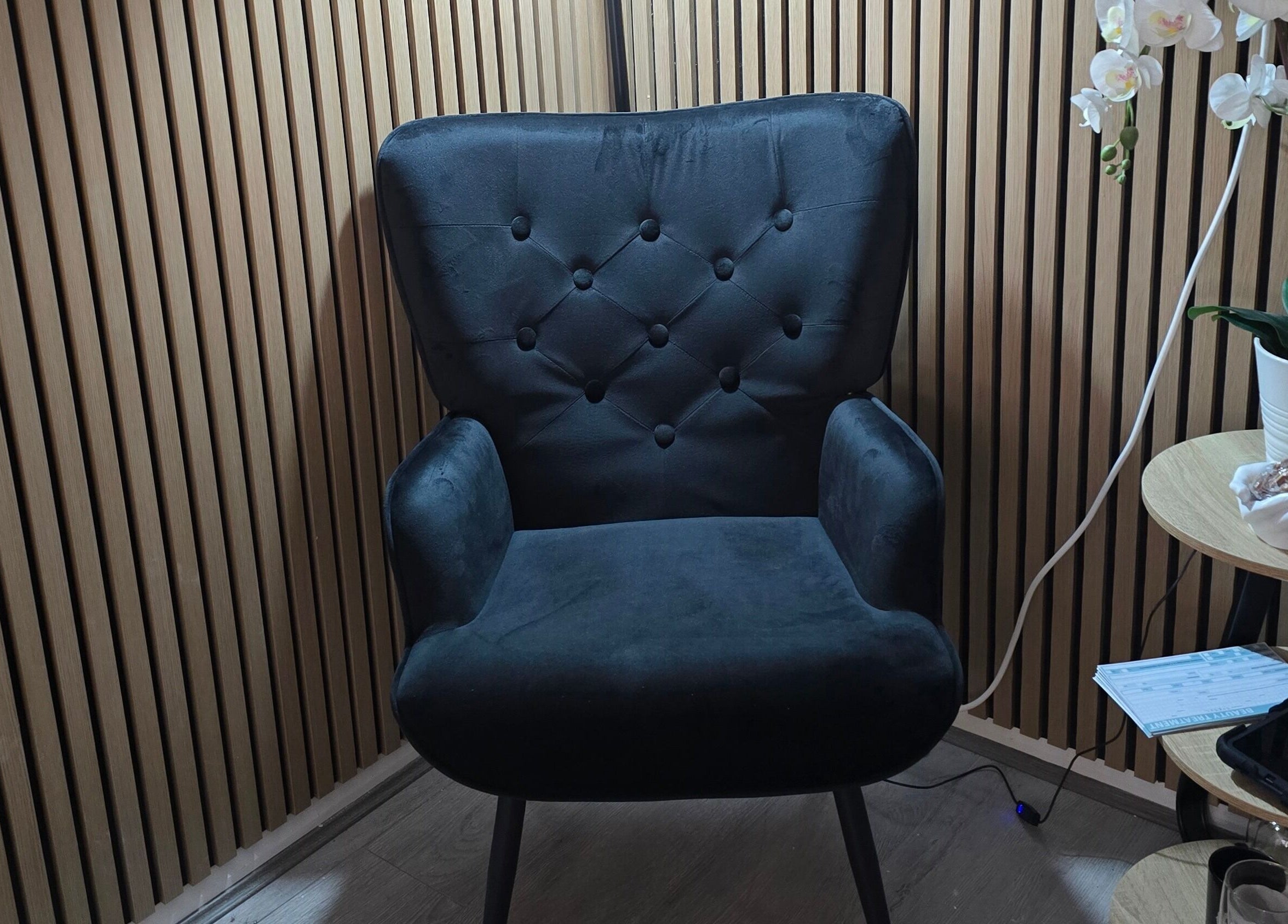 Elegant velvet chair at Face it by Ian, Walton-on-Thames, England, GB, perfect for relaxation.