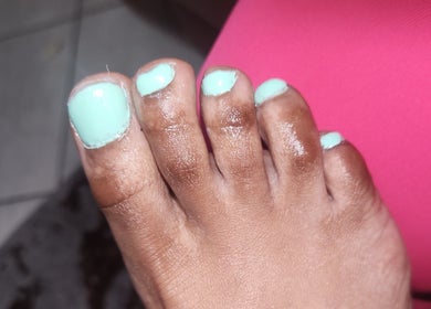 Mint green pedicure on toes at Lee's Beauty, Cape Town, Western Cape, ZA. Vibrant wellness care.