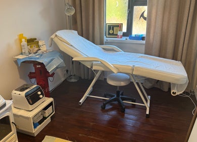 Treatment room at The Healing Place Global LTD, Taverham, England, featuring a comfy bed and serene decor.