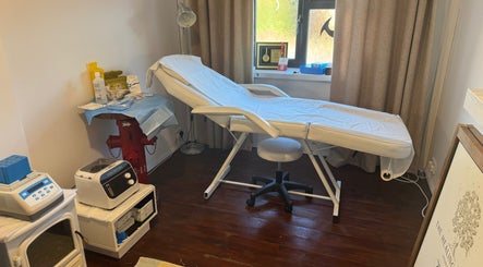 Treatment room at The Healing Place Global LTD, Taverham, England, featuring a comfy bed and serene decor.