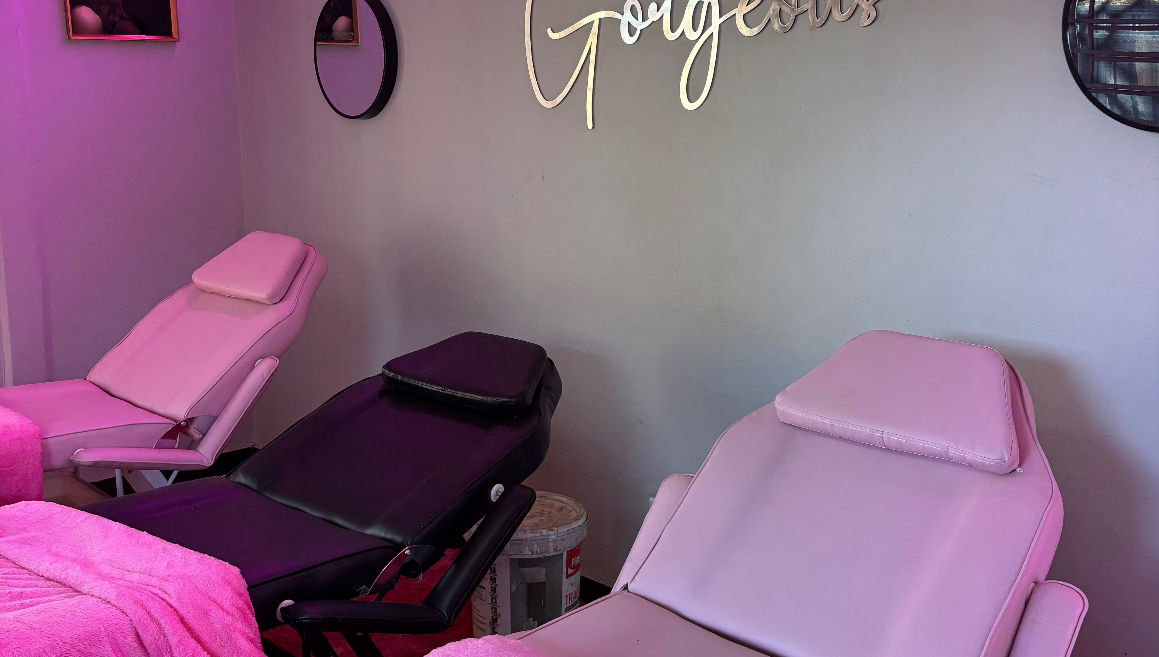 Comfortable beauty chairs at BLINQ EYELASH EXTENSIONS, Lusaka, Lusaka Province, ZM, with pink decor and elegant mirrors.