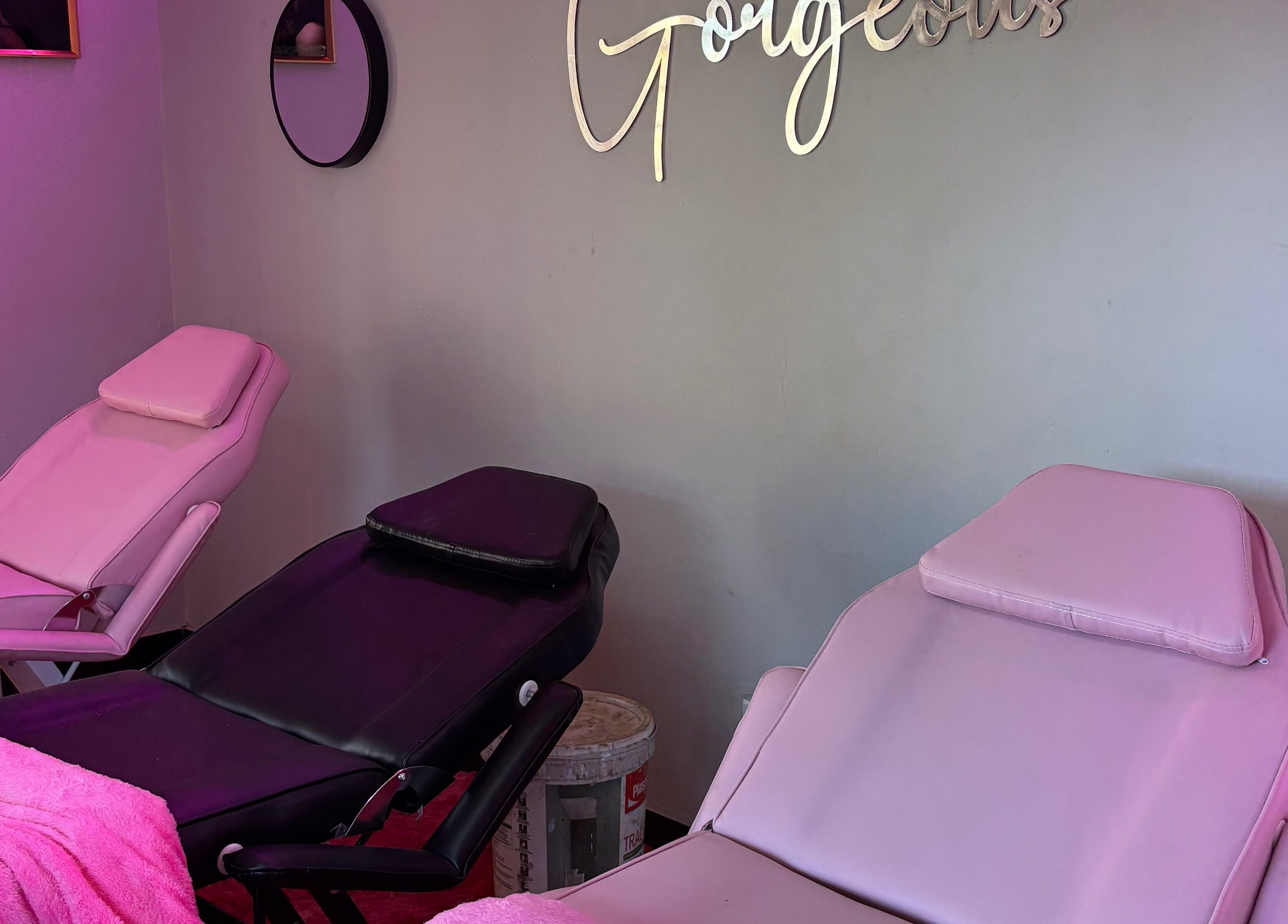 Comfortable beauty chairs at BLINQ EYELASH EXTENSIONS, Lusaka, Lusaka Province, ZM, with pink decor and elegant mirrors.