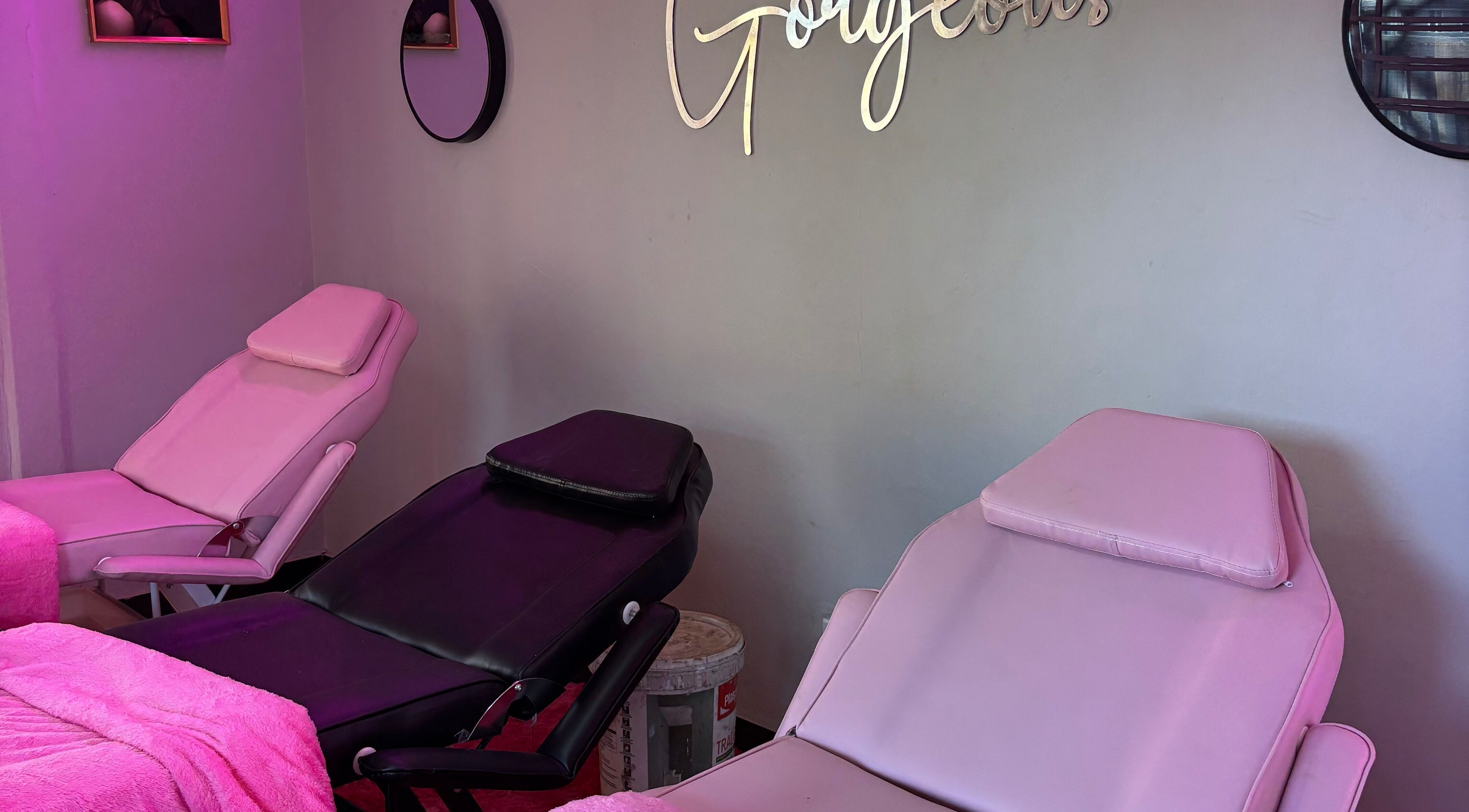 Comfortable beauty chairs at BLINQ EYELASH EXTENSIONS, Lusaka, Lusaka Province, ZM, with pink decor and elegant mirrors.