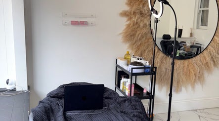 Cozy beauty setup at Noora's Beauty Lab in Edinburgh, Scotland, GB, featuring a mirror and soft lighting.