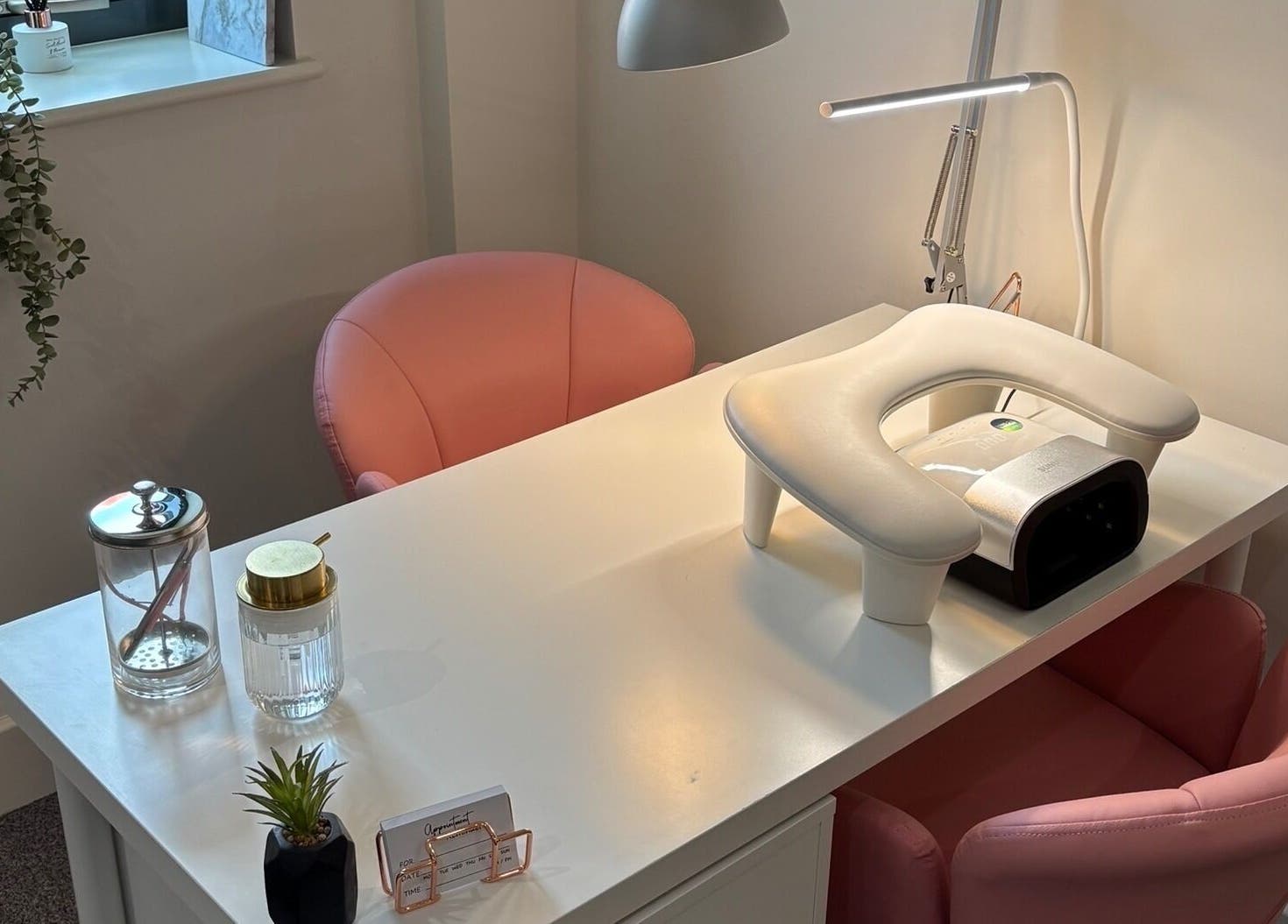 SJ Studio's chic manicure station in Amble, England, GB with plush seating and modern decor.