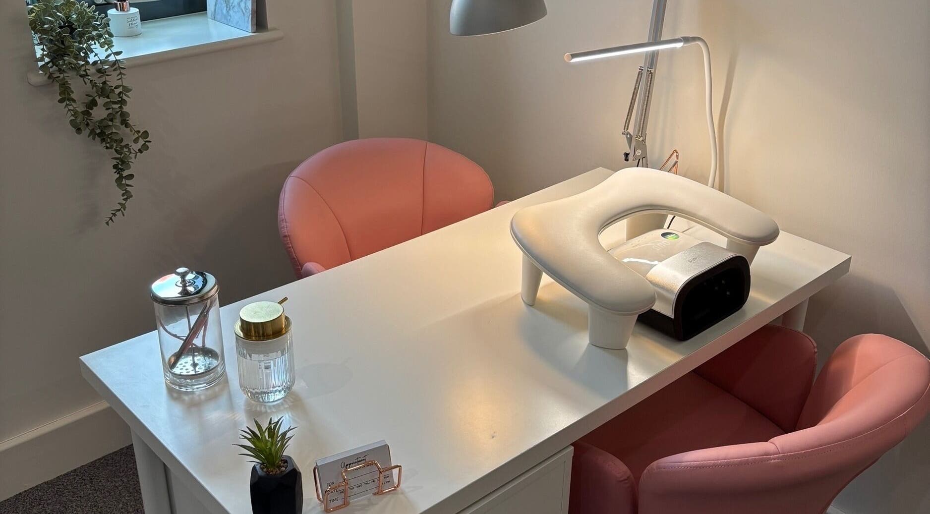 SJ Studio's chic manicure station in Amble, England, GB with plush seating and modern decor.