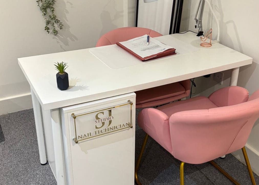 SJ Studio nail technician desk with pink chairs in Amble, England, GB.