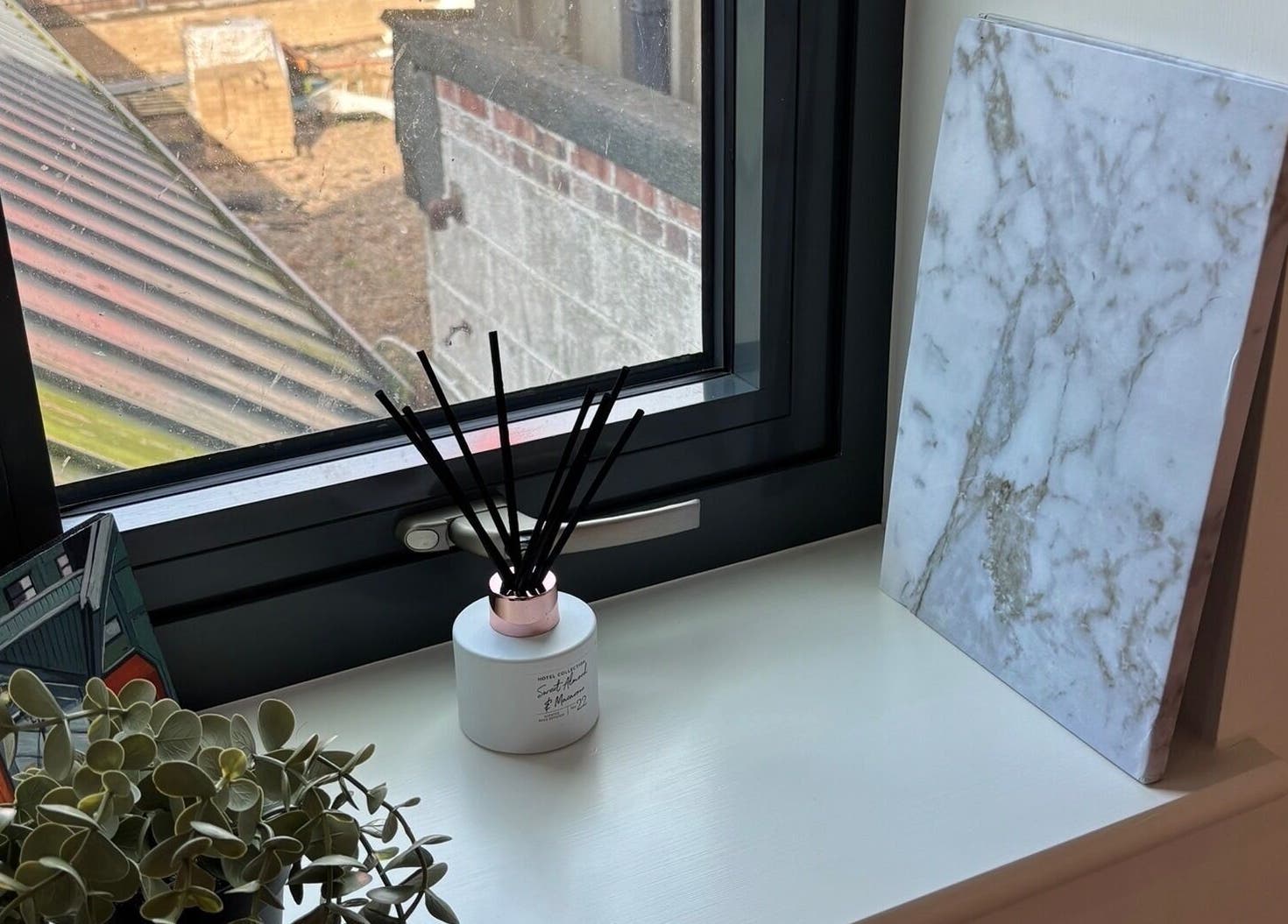 Elegant window sill decor with diffuser at SJ Studio, Amble, England, GB.