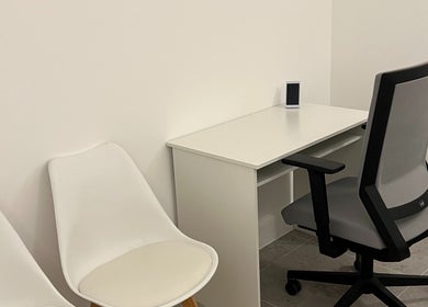 Sleek workspace at AtelieRx, St Albans, England, GB with desk, chair, and minimalist decor.