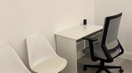 Sleek workspace at AtelieRx, St Albans, England, GB with desk, chair, and minimalist decor.